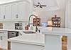 Fully equipped modern Kitchen w/ quartz countertops, breakfast bar & bright dining nook 
