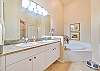 The en-suite primary bathroom features double sinks, a soaking tub and separate shower