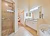 The en-suite primary bathroom features double sinks, a soaking tub and separate shower