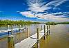 Common owned area at the east bay-end of the street with boat ramp for kayaks and pontoon boats (shallow), 2 docks and bench. 