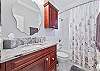 A shower-tub combo in the guest bathroom