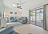 Family room with TV. Sliding door to the pool area