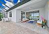 Very comfortable teak seating furniture in the covered lanai. 