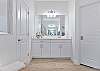 The en-suite bathroom features dual sinks, soaking tub and spacious walk-in shower.