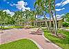 The Wedgewood at Bonita Bay pool area includes a clubhouse and grilling station