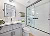 The guest bathroom features a shower-tub combo