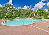 The Wedgewood at Bonita Bay pool area includes a clubhouse and grilling station