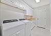 Spacious laundry room with sink, washer and dryer