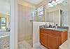 The en-suite primary bathroom features his and her vanity, and a separate shower and tub