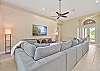 Family room with spacious sectional and TV. 
