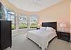 A queen size bed and smart TV in the guest bedroom. Darkening roller shades are installed in all bedrooms.