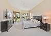 A king size bed and smart TV in the primary suite. Darkening roller shades are installed in all bedrooms.