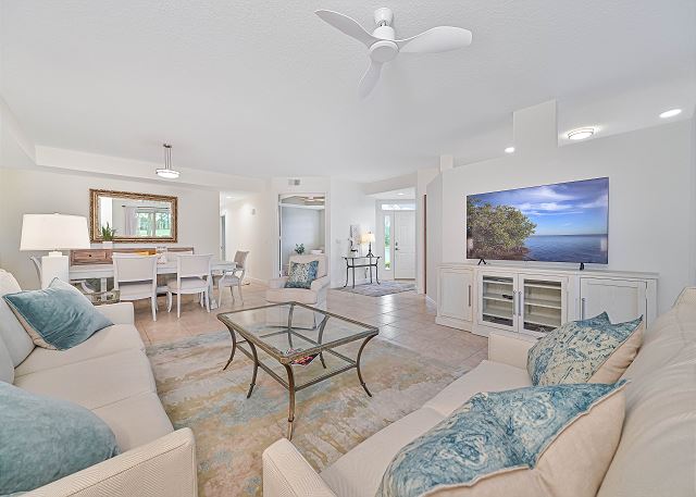 Spacious and light living area with TV. Sliding doors to the patio with gorgeous lake and golf course view