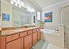 Dual sinks, a soaking tub and a separate shower in the primary bathroom