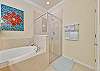 A soaking tub and shower in the primary bathroom