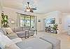 Spacious living with flat screen TV and sliding doors opening to the pool area