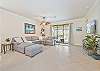 Spacious living with flat screen TV and sliding doors opening to the pool area
