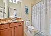 The en-suite guest bathroom features a shower-tub combo