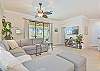 Spacious living with flat screen TV and sliding doors opening to the pool area