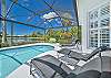 Screened in pool area with heated pool and spa. The panoramic cage offers a stunning lake view