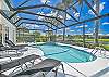 Screened in pool area with heated pool and spa. The panoramic cage offers a stunning lake view