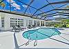 Screened in pool area with heated pool and spa. The panoramic cage offers a stunning lake view