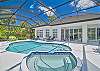 Screened in pool area with heated pool and spa. The panoramic cage offers a stunning lake view