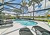 Screened in pool area with heated pool and spa. The panoramic cage offers a stunning lake view