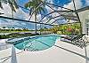 Screened in pool area with heated pool and spa. The panoramic cage offers a stunning lake view