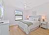 A queen bed and smart TV in the guest bedroom