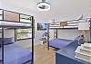 The third bedroom is equipped with two bunk beds, kid themed decor, and closet space. Kids can even enjoy their own smart TV!
