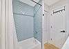A shower-tub combo in the guest bathroom