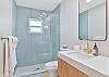 Dual sinks and a spacious shower in the en-suite  primary bathroom
