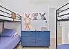 The third bedroom is equipped with two bunk beds, kid themed decor, and closet space. Kids can even enjoy their own smart TV!