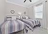 Two full beds and smart TV in the third guest bedroom