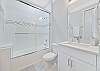 The guest bathroom features a shower-tub combo