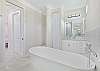 The en-suite primary bathroom features a spacious shower, double vanities and an inviting soaking tub