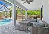 Covered outdoor seating & dining area with smart TV & BBQ