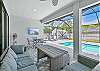 Covered outdoor seating & dining area with smart TV & BBQ