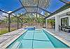 Screened in pool area with heated pool and spa