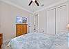 A queen bed and smart TV in the guest bedroom