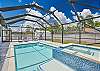 Screened in pool area with heated pool and spa
