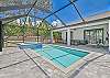Screened in pool area with heated pool and spa