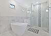 The en-suite primary bathroom features a spacious shower, double vanities and an inviting soaking tub