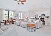 Family room with large smart TV, dining area and kitchen with island seating