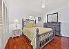 A queen bed and custom office nook in the guest bedroom