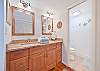 The en-suite primary bathroom features double sinks and a spacious shower