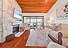 TV over the fireplace, and sliding doors opening to the screened in balcony