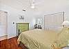 A queen bed and custom office nook in the guest bedroom