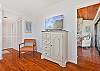 Primary suite with a queen size bed and TV